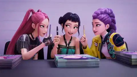 Rumi (Arden Cho), May Hong (Mira), and Ji-young Yoo (Zoey) click pens while saying 'Happy Honmoon!' in the KPop Demon Hunters game.